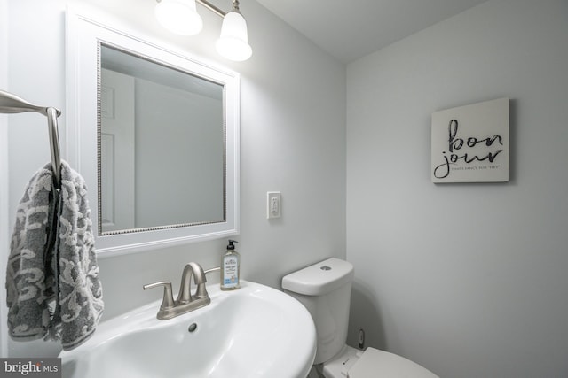 bathroom featuring toilet and sink