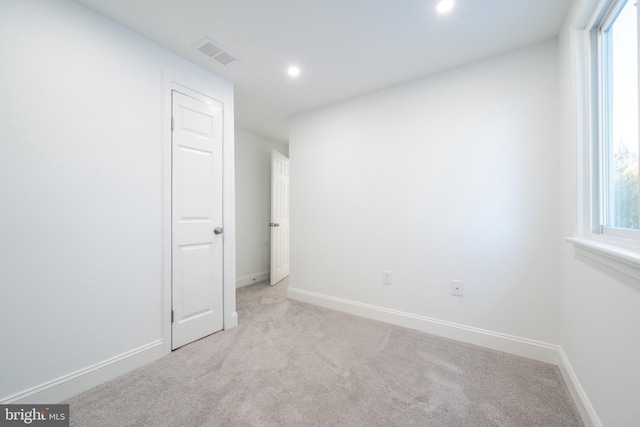 spare room with light carpet