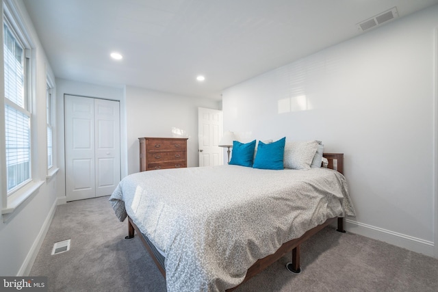 carpeted bedroom with a closet