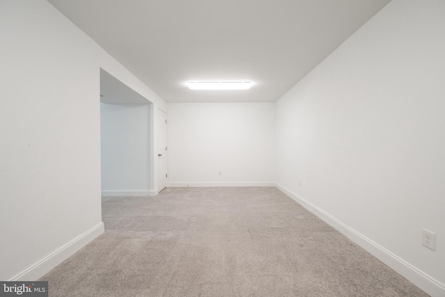 unfurnished room featuring light colored carpet