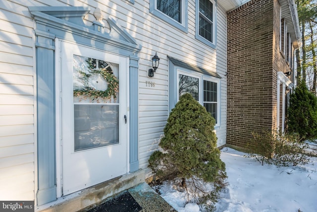 view of snow covered property entrance