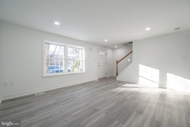 unfurnished living room with hardwood / wood-style floors