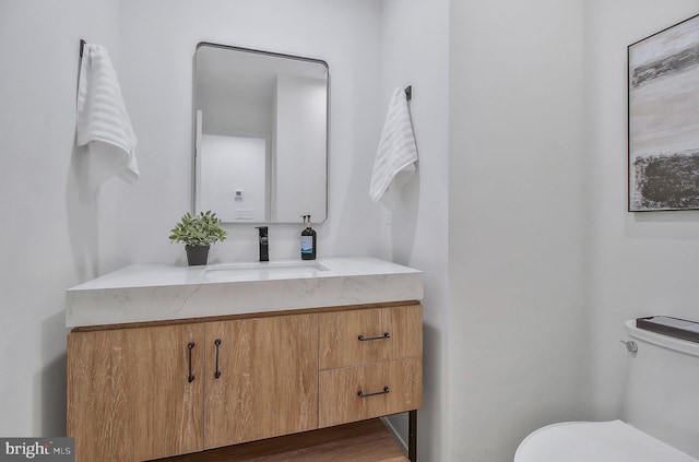 bathroom featuring vanity and toilet