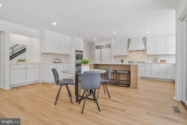 dining area with light hardwood / wood-style floors