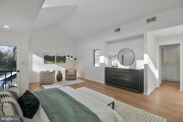 bedroom featuring access to exterior, vaulted ceiling, and light wood-type flooring