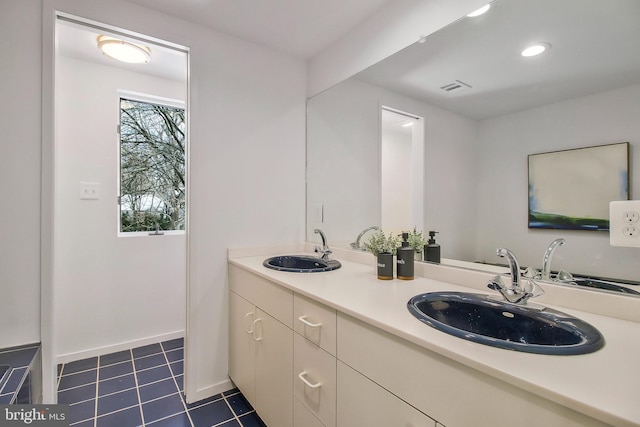 bathroom with tile patterned flooring and vanity