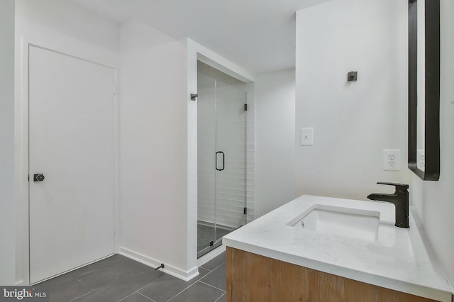 bathroom featuring tile patterned flooring, vanity, and a shower with shower door