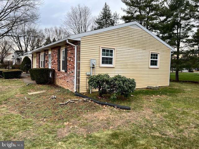 view of home's exterior with a lawn