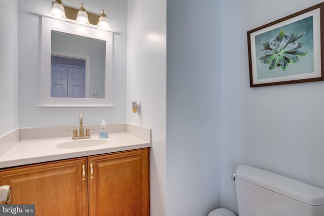 bathroom featuring toilet and vanity