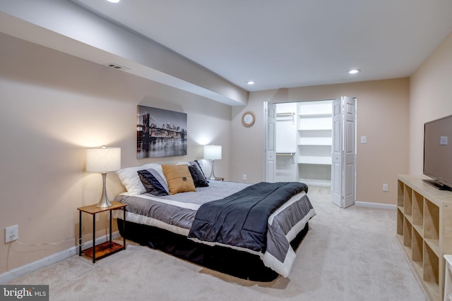 carpeted bedroom featuring a closet and a spacious closet