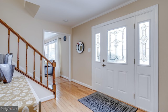 entrance foyer with light wood-type flooring and ornamental molding