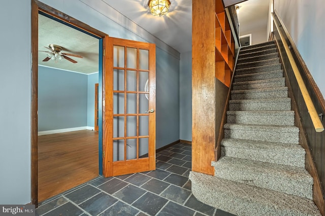 stairway with french doors and ceiling fan