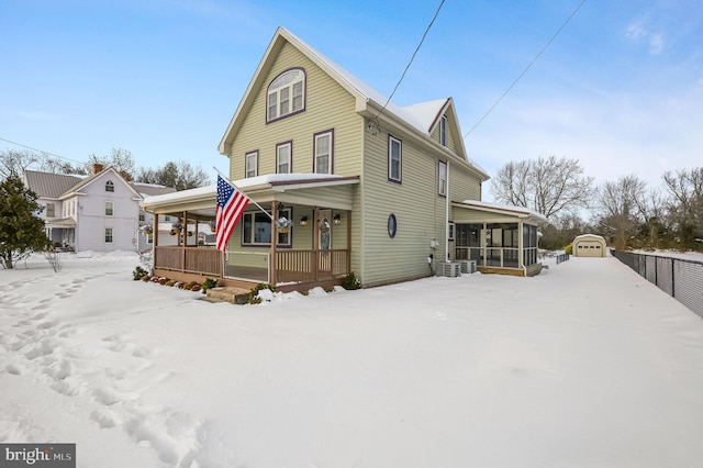 view of front of property with a porch, an outdoor structure, and a garage