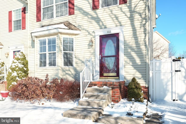 view of snow covered property entrance