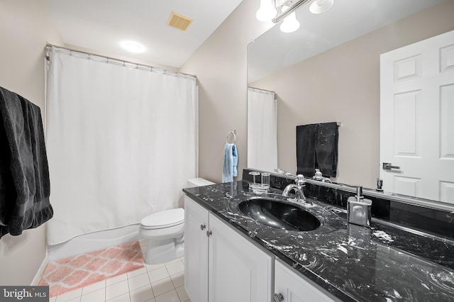 bathroom with tile patterned flooring, vanity, and toilet