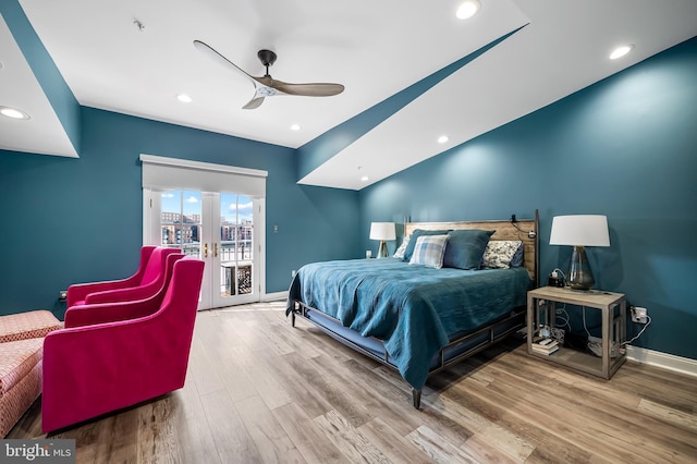 bedroom featuring ceiling fan, french doors, hardwood / wood-style flooring, and access to exterior