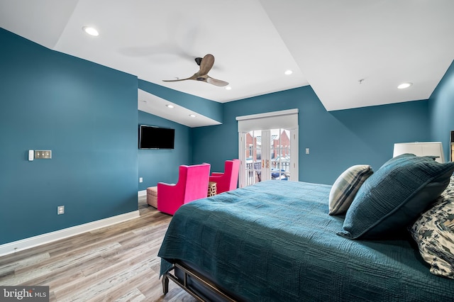 bedroom featuring access to outside, vaulted ceiling, french doors, light hardwood / wood-style floors, and ceiling fan