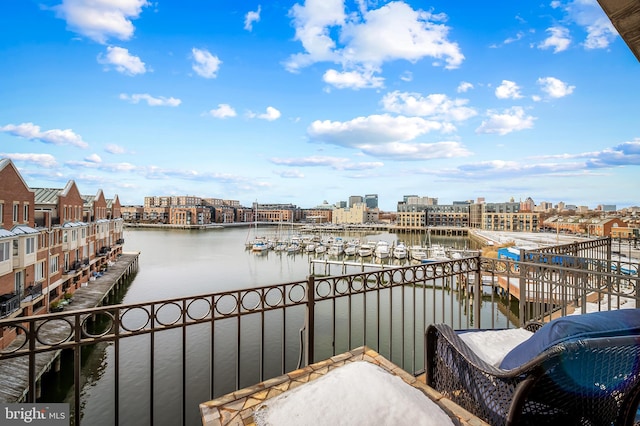 balcony with a dock and a water view