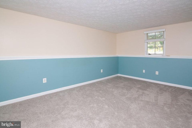 empty room featuring carpet floors and a textured ceiling