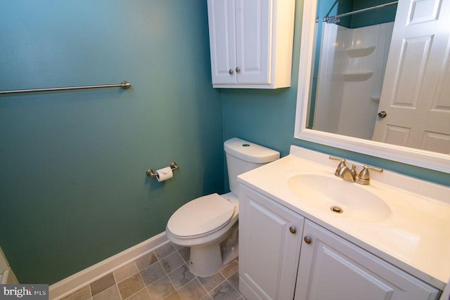 bathroom with vanity, toilet, and walk in shower