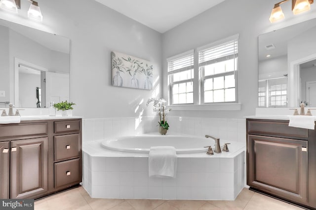 bathroom with tile patterned flooring, vanity, and shower with separate bathtub