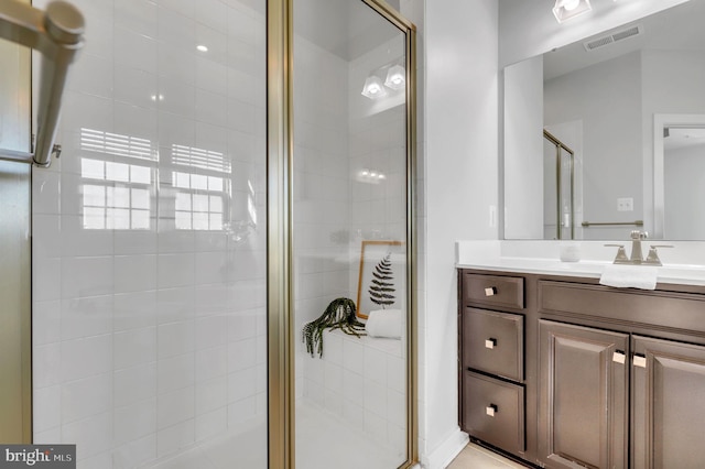 bathroom with a shower with door and vanity