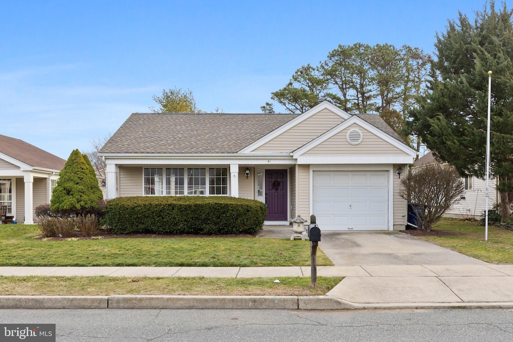 ranch-style house with a garage and a front yard