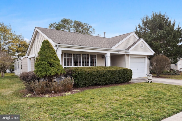 ranch-style house featuring a front lawn and a garage