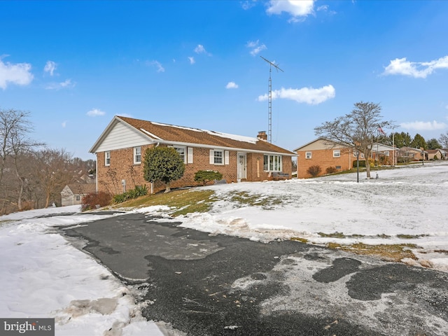 view of snow covered back of property