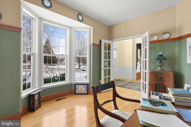 office featuring light hardwood / wood-style floors and french doors