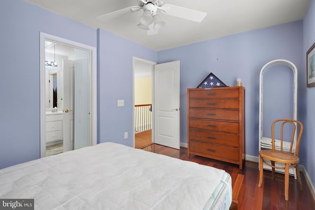 bedroom with ceiling fan, ensuite bathroom, and dark wood-type flooring