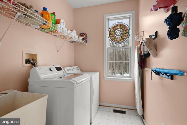 clothes washing area featuring sink and washing machine and dryer