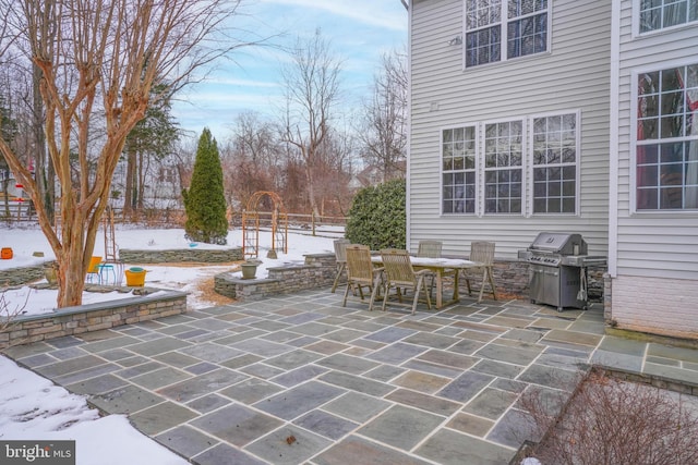 snow covered patio with grilling area