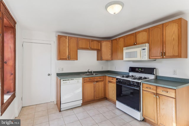 kitchen with white appliances, sink, and light tile patterned floors