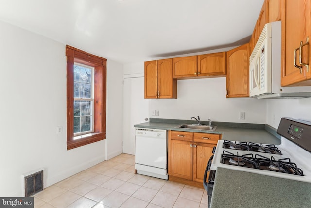 kitchen with sink, white appliances, and light tile patterned floors