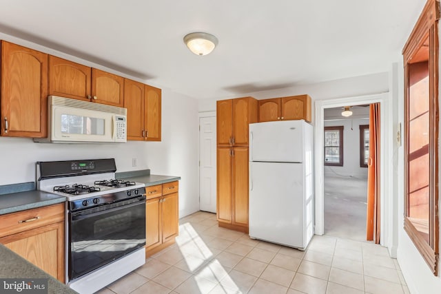 kitchen featuring white appliances and light tile patterned floors