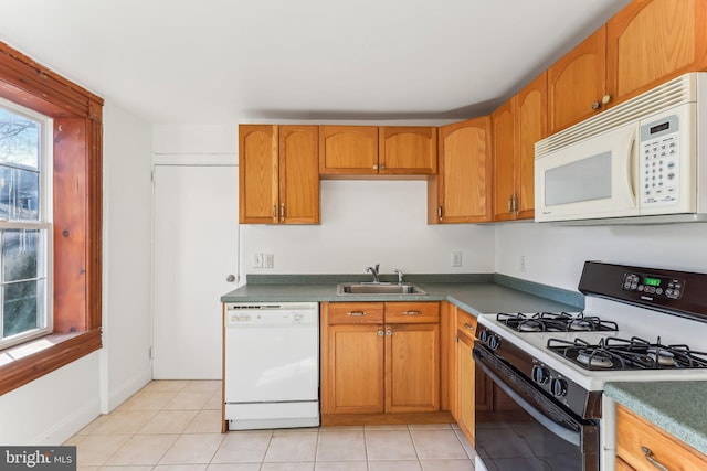 kitchen with white appliances, light tile patterned floors, and sink