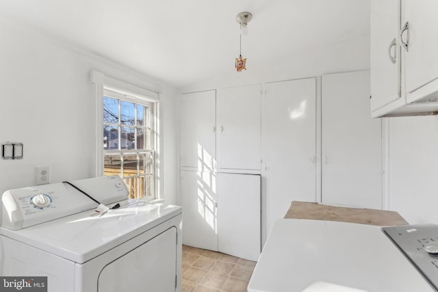 laundry area featuring independent washer and dryer and cabinets