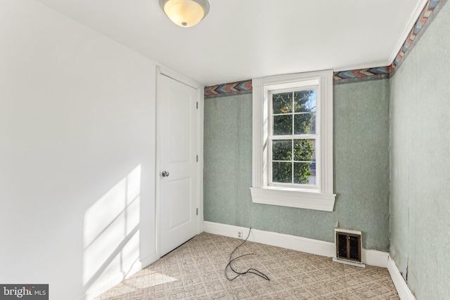 carpeted empty room with plenty of natural light