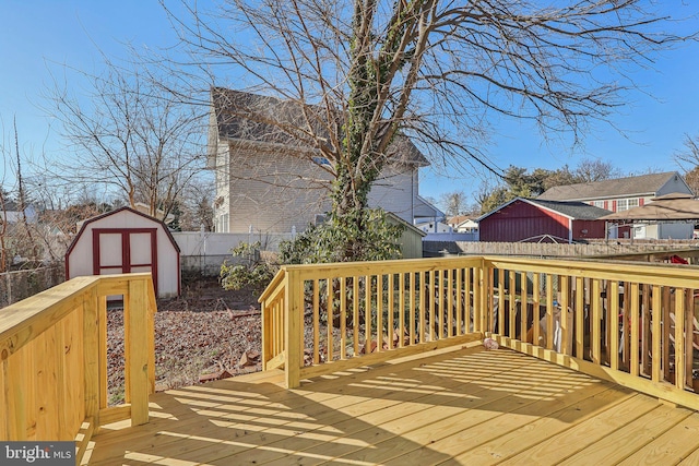 wooden deck featuring a storage unit