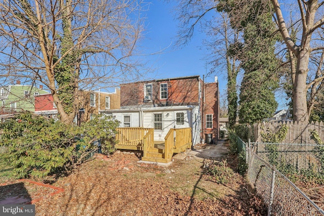 rear view of property with a wooden deck