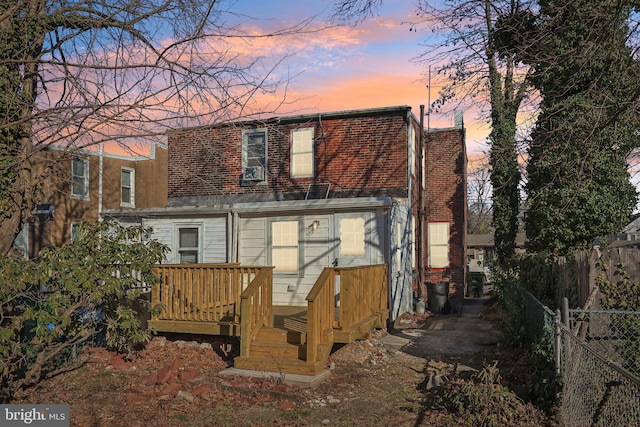 view of back house at dusk