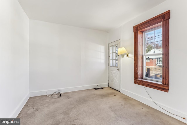 unfurnished room with light colored carpet