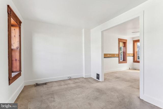 unfurnished room with light colored carpet