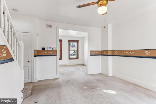 interior space featuring ceiling fan and light carpet