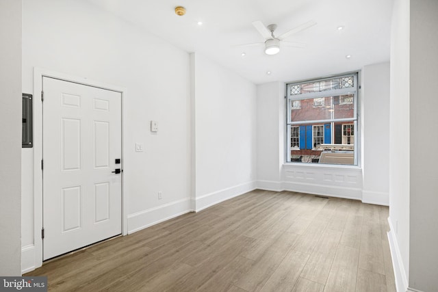 unfurnished room with ceiling fan, baseboards, and wood finished floors