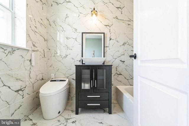 bathroom featuring toilet, vanity, and a bathtub