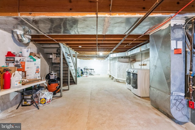 basement featuring washing machine and dryer and heating unit