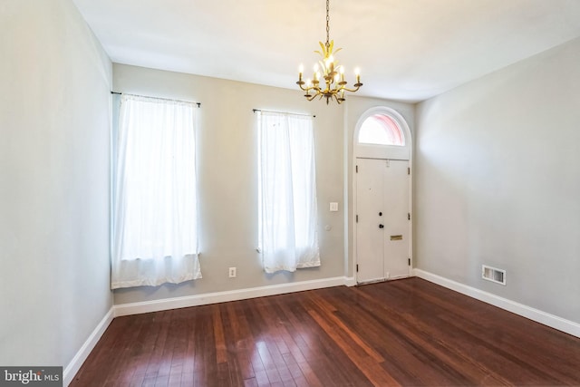 entryway featuring dark hardwood / wood-style flooring and a notable chandelier