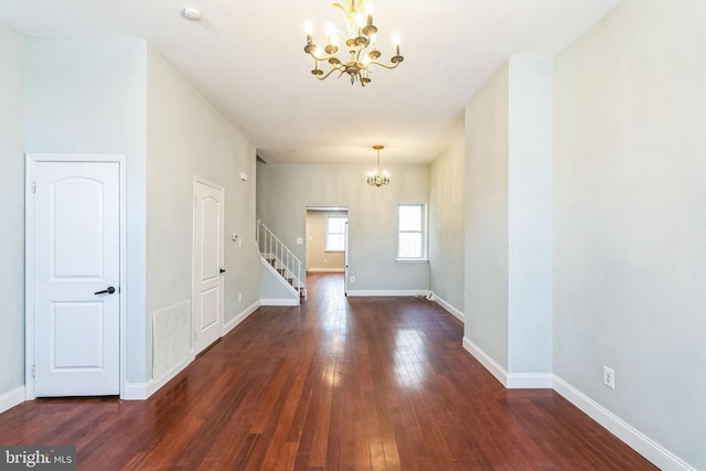 interior space featuring a notable chandelier and dark hardwood / wood-style floors